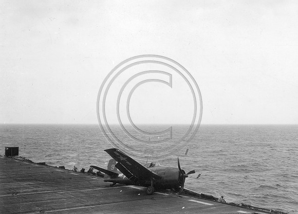 F-6F Hellcat Fighter come in for a crash landing aboard the Bonne Homme Richard