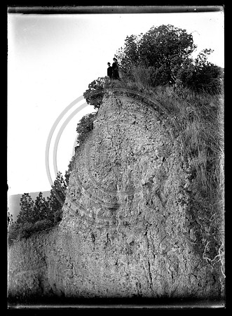 People standing atop large cliff
