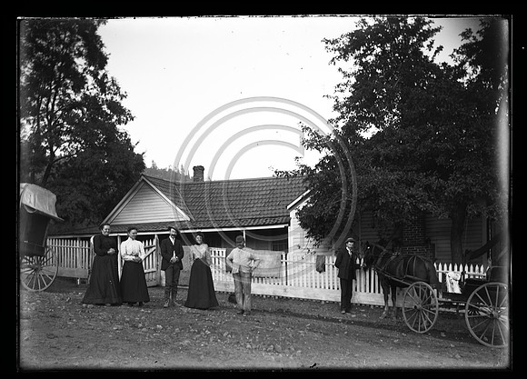 Victorian couple in front house with buggys scanned 3-30-2012 from 5x7 glass negative