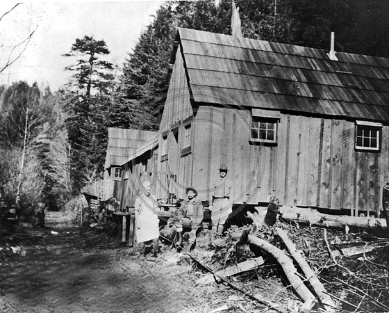 1st camp built by the Pacific Lumber Company in Freshwater This was their winter quarters for the survey crew during 1919 to 1920 built on the little Freshwater man in the center is Robert Beach