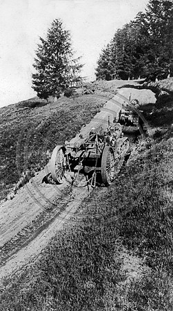 A Cat towing a High Wheel up the mountain