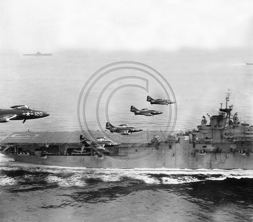 Navy Grunman Panther Fighters fly by the Bonne Homme Richard an Essex class carrier